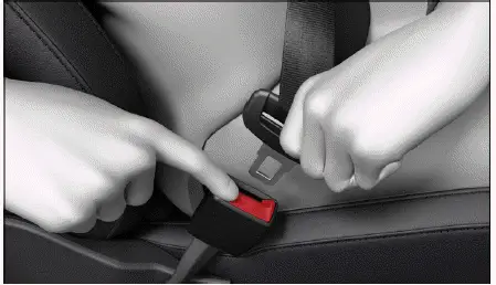 Volkswagen ID.4 pressing red button to release seat belt buckle