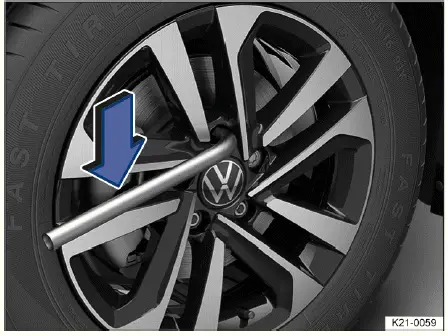 Volkswagen ID.4 loosening wheel bolts with lug wrench correct technique before lifting