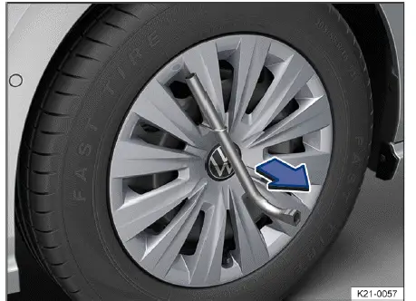 Volkswagen ID.4 removing full wheel hub cover using extraction hook lug wrench assistance